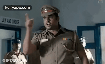 A Police Officer Is Giving A Speech In A Police Station . GIF