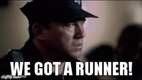 A Police Officer Is Standing In Front Of A Crowd And Says `` We Got A Runner ! '' GIF