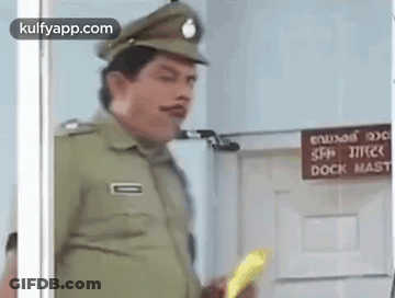 A Police Officer Is Standing In Front Of A Door Holding A Yellow Object . GIF
