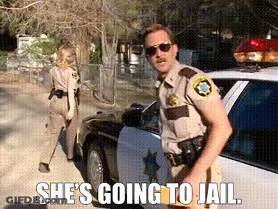 A Police Officer Is Standing In Front Of A Police Car With A Caption That Says She 'S Going To Jail GIF