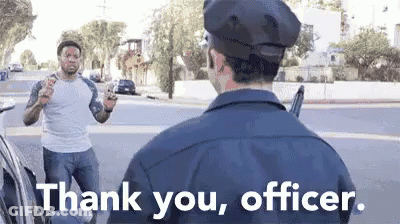 A Police Officer Is Talking To A Man Who Is Holding A Gun In His Hand . GIF