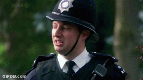 A Police Officer Says Go To Prison In Front Of Trees GIF