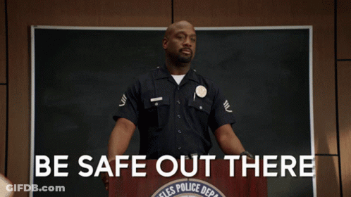 A Police Officer Stands At A Podium With The Words Be Safe Out There GIF