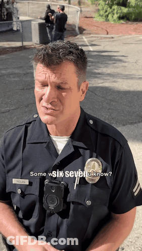 A Police Officer Wearing A Badge That Says Nolan On It GIF