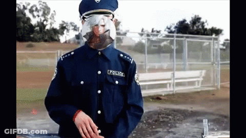 A Police Officer Wearing A Mask And Glasses GIF