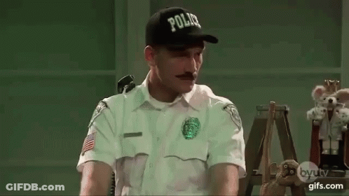 Police Officer Sitting At Desk GIF