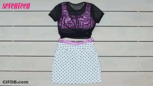 A Polka Dot Skirt And A Purple Top Are On A Wooden Table GIF