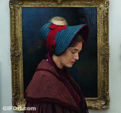 A Portrait Of A Woman Wearing A Blue Hat GIF