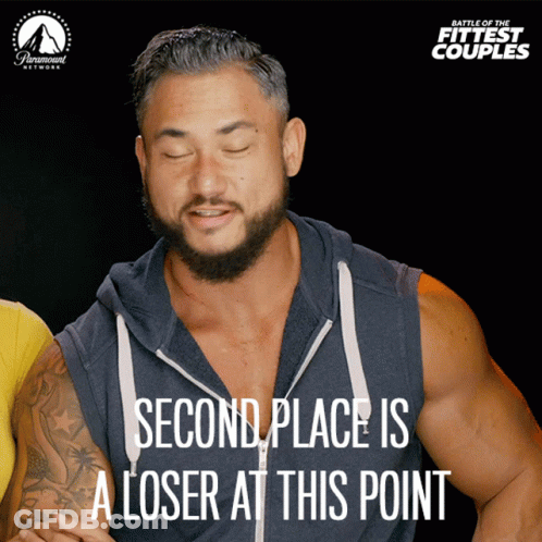 A Poster For Battle Of The Fittest Couples Shows A Man With His Eyes Closed And Says Second Place Is A Loser At This Poi GIF