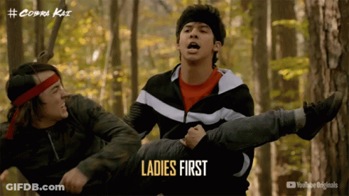 A Poster For Cobra Kai Shows A Man Carrying Another Man On His Shoulders GIF