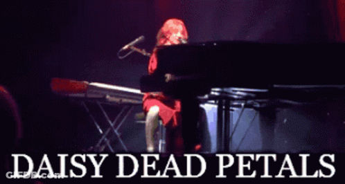 A Poster For Daisy Dead Petals Shows A Woman Playing A Keyboard GIF