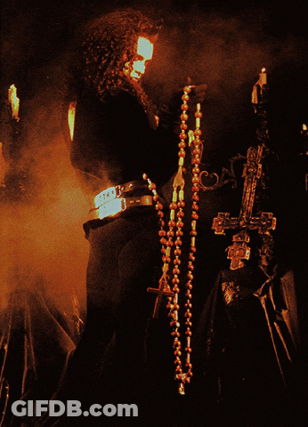 A Poster For Dead Or Alive Features A Man Holding A Cross GIF