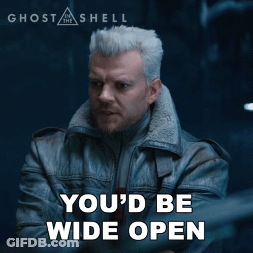 A Poster For Ghost In The Shell Shows A Man In A Leather Jacket With His Arms Crossed GIF