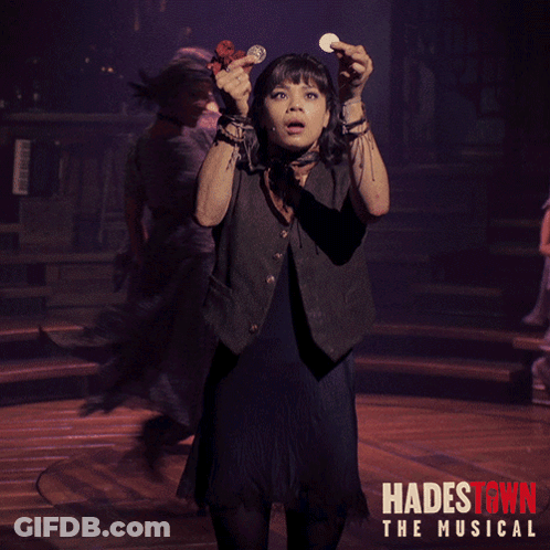 A Poster For Hadestown The Musical Shows A Girl Holding A Coin In Her Hand GIF