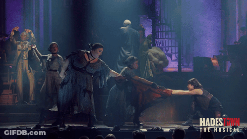 A Poster For Hadestown The Musical Shows A Group Of People Dancing On A Stage GIF