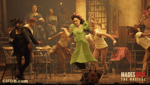 A Poster For Hadestown The Musical Shows A Group Of People Dancing On Stage GIF
