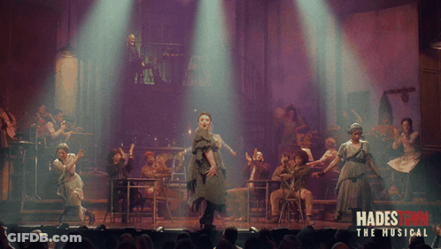 A Poster For Hadestown The Musical Shows A Group Of People Performing On Stage GIF