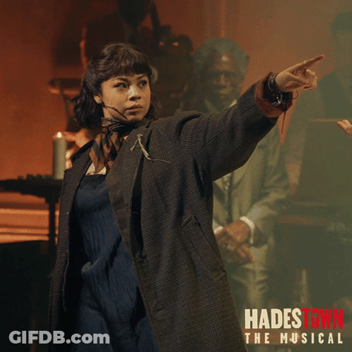 A Poster For Hadestown The Musical Shows A Woman Pointing Her Finger GIF