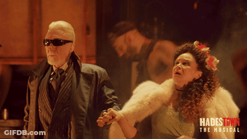 A Poster For Hadestown The Musical Shows Two People Holding Hands GIF