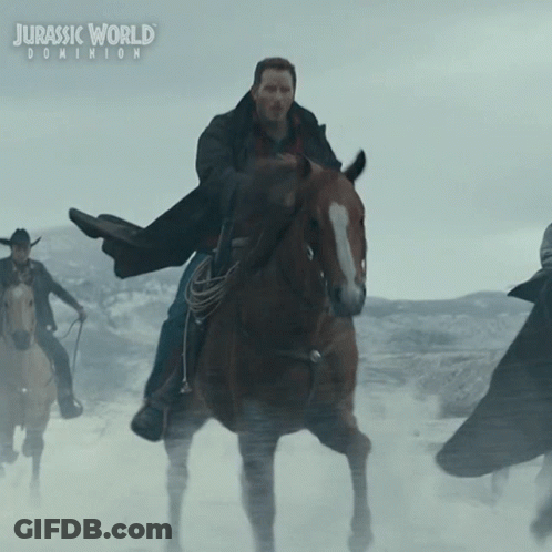 A Poster For Jurassic World Dominion Shows A Man Riding A Brown Horse GIF