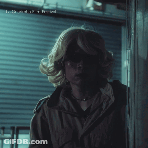 A Poster For La Guarimba Film Festival Shows A Woman In A Blonde Wig GIF