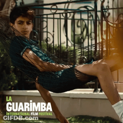 A Poster For La Guarimba International Film Festival With A Man Laying In A Hammock GIF