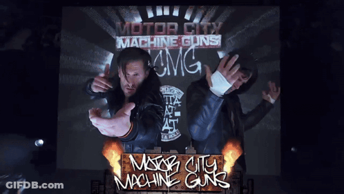 A Poster For Motor City Machine Guns Shows Two Men On A Stage GIF