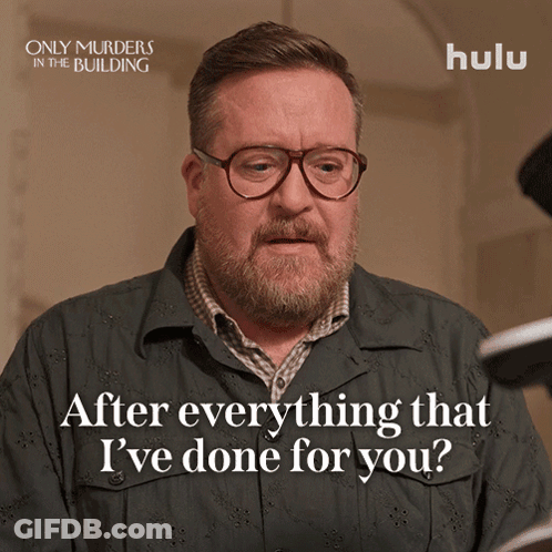 A Poster For Only Murders In The Building Shows A Man With Glasses And A Beard GIF