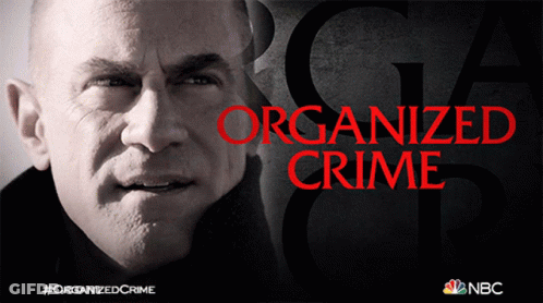 A Poster For Organized Crime Shows A Man 'S Face GIF