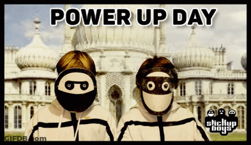 A Poster For Power Up Day With Two Masked Boys In Front Of A Building GIF