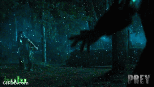 A Poster For Prey Shows A Man Being Attacked By A Monster In The Woods GIF