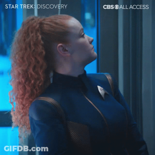 A Poster For Star Trek Discovery Shows A Woman With Red Hair Making A Funny Face GIF