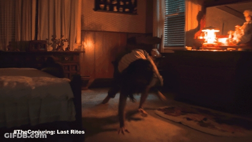 A Poster For The Conjuring Last Rites Shows A Woman Doing Push Ups GIF