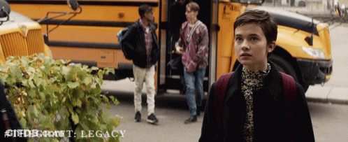 A Poster For The Craft Legacy Shows A Girl Standing In Front Of A Bus GIF