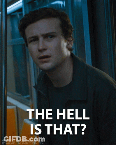 A Poster For The Escape Room Movie Shows A Man And The Words The Hell Is That GIF
