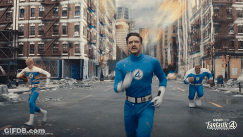 A Poster For The Fantastic Four Shows Three Men Running Through A City GIF
