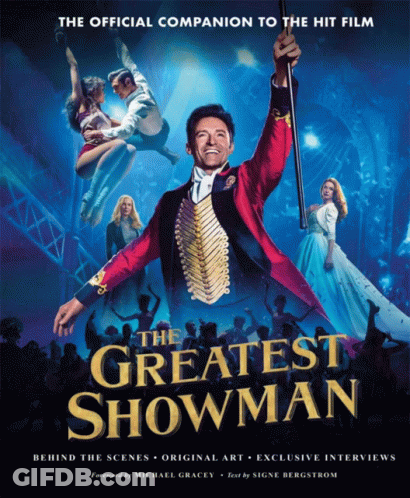 A Poster For The Greatest Showman Shows A Man In A Red Suit Holding A Cane GIF