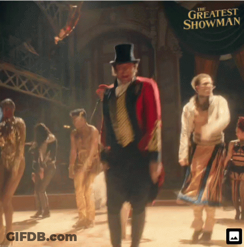 A Poster For The Greatest Showman Shows A Man In A Top Hat GIF