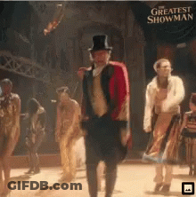 A Poster For The Greatest Showman With A Man In A Top Hat GIF