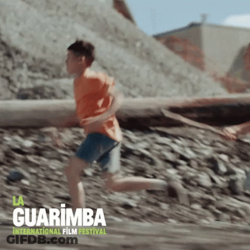 A Poster For The Guarimba International Film Festival With A Boy Running GIF
