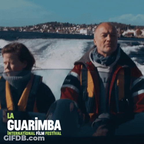 A Poster For The La Guarimba International Film Festival Shows A Man And A Woman In A Boat GIF