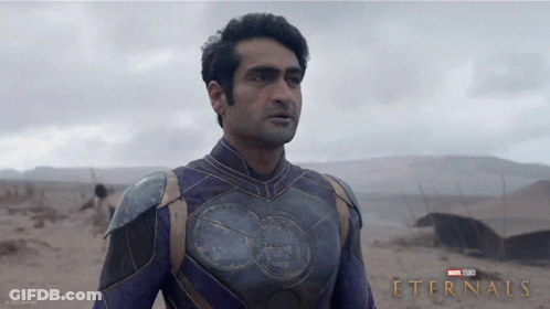 A Poster For The Movie Eternals Shows A Man In A Purple Armor GIF