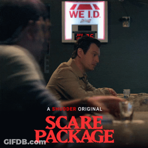 A Poster For The Movie Scare Package Shows Two Men Sitting At A Bar GIF