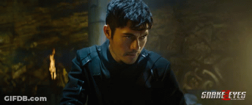 A Poster For The Movie Snake Eyes Shows A Man In A Black Jacket GIF