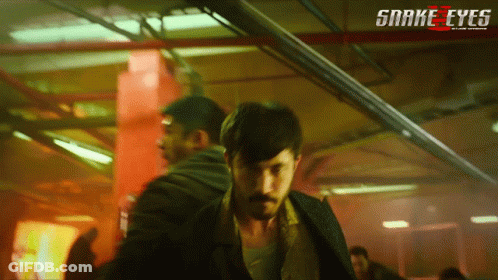 A Poster For The Movie Snake Eyes Shows A Man With A Mustache GIF