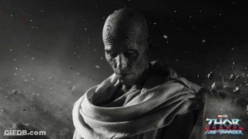 A Poster For The Movie Thor Lone Thunder Shows A Bald Man With Red Eyes GIF