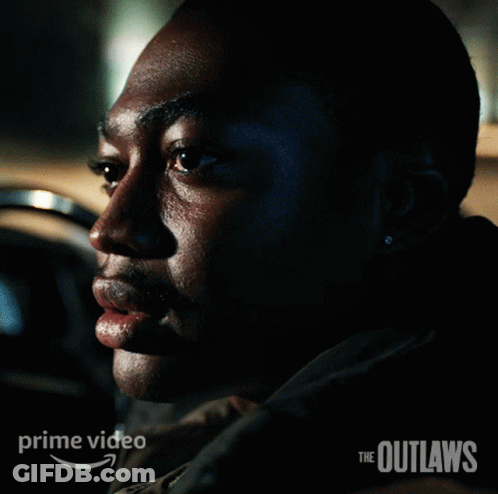 A Poster For The Outlaws Shows A Man Sitting In A Car GIF