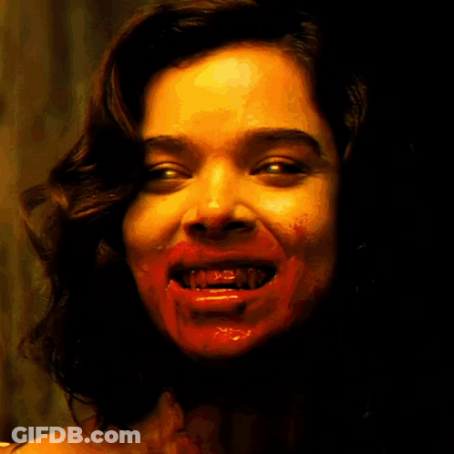 A Poster Of A Woman With Blood On Her Face And The Words Denims Factory Below Her GIF