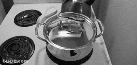 A Pot Is Sitting On Top Of A Stove With The Lid Open . GIF