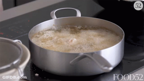 A Pot Of Food Is Being Cooked On A Stove With The Number 52 Above It GIF